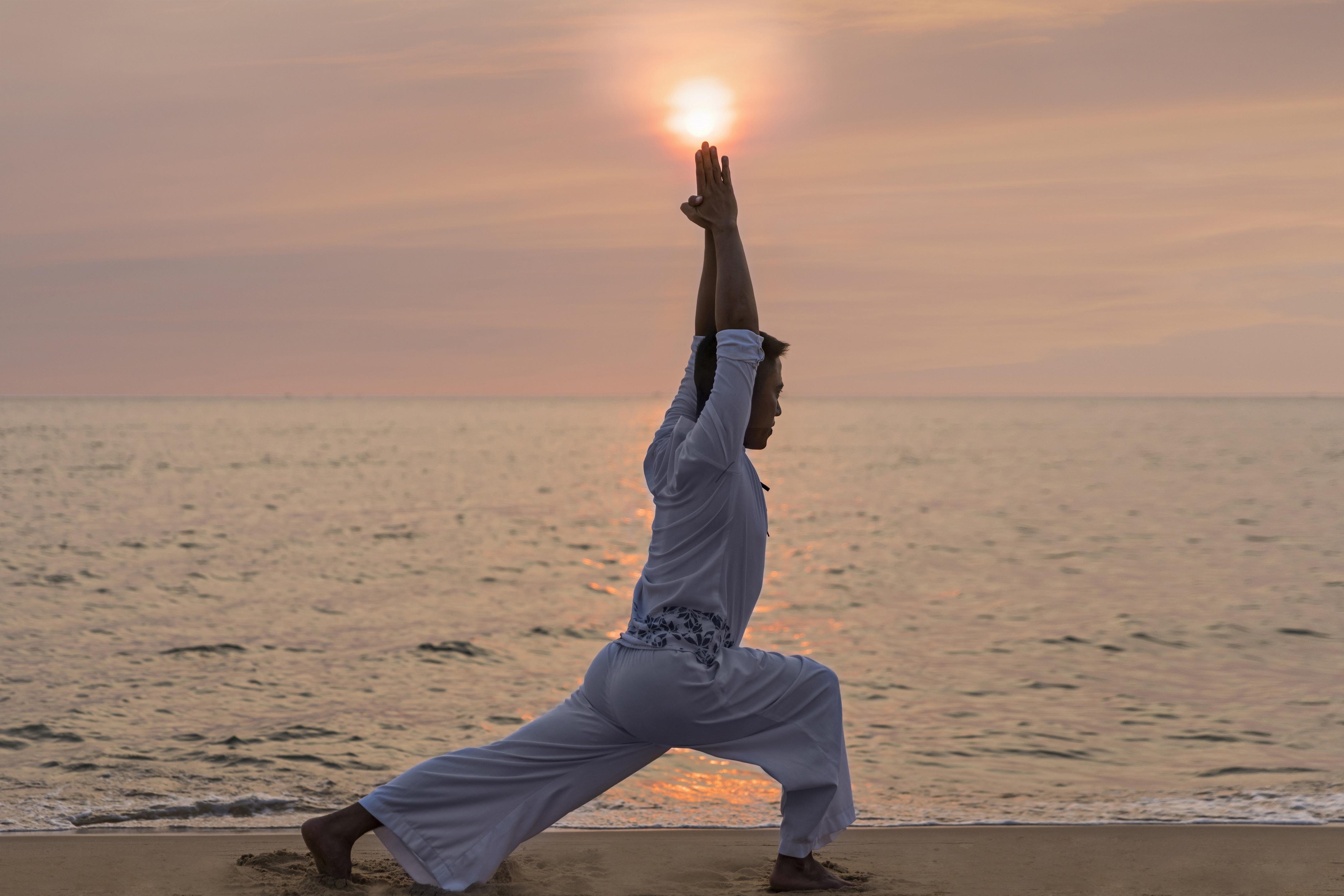 Sol By Melia Phu Quoc Hotell Exteriör bild A man practicing yoga at the beach